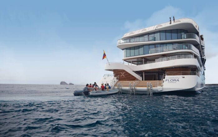 Celebrity Flora stern view with zodiac boats Galapagos