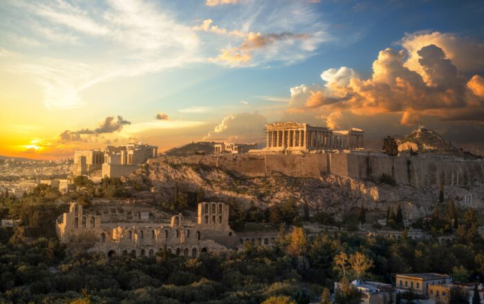 The Acropolis of Athens and Parthenon glowing at sunset above the city.