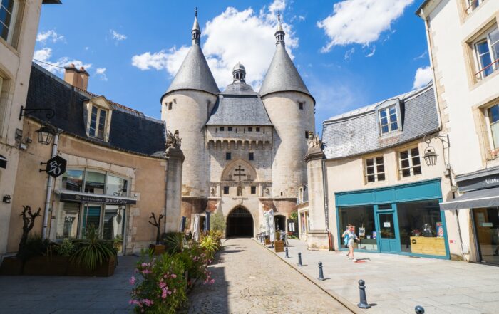 Porte de la Craffe in Nancy, Lorraine, France — a medieval city gate with twin towers, surrounded by charming cobblestone streets and historic architecture, often visited on French river cruises.