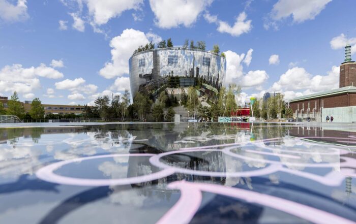 Reflective modern building in Rotterdam with surrounding cityscape in the Netherlands, a highlight on the Netherlands by cruise urban stops.