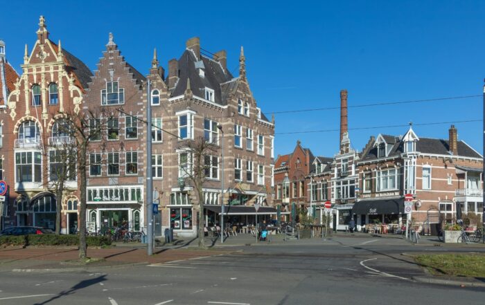 Historic town square with Dutch cafés and traditional brick buildings in the Netherlands near popular river cruise ports.