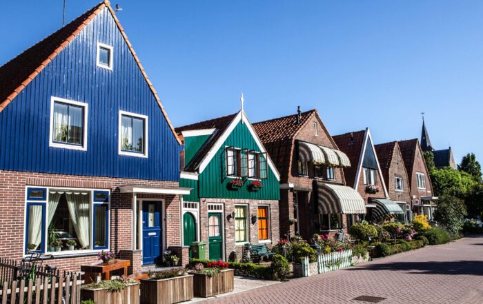 Traditional colorful Dutch houses lining a quiet street in the Netherlands, commonly explored in the Netherlands.