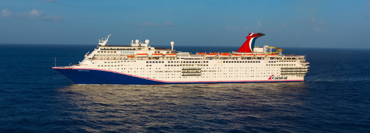 The Carnival Elation, a large cruise ship operated by Carnival Cruise Line, sails through open