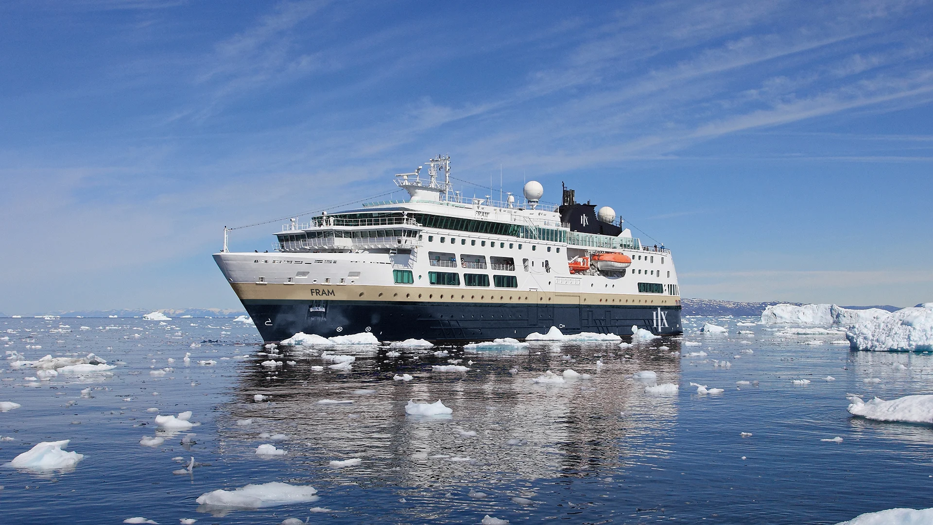 A modern expedition cruise ship navigates through pack ice in an Arctic setting, surrounded by floating icebergs under a clear blue sky. The vessel is designed for polar exploration with reinforced hull and advanced navigation systems visible on its superstructure.