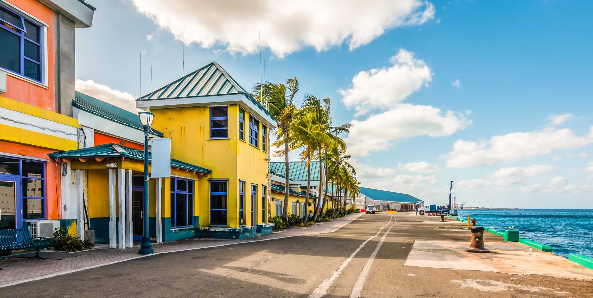 A vibrant cruise port terminal in Nassau, Bahamas, featuring brightly colored buildings in yellow