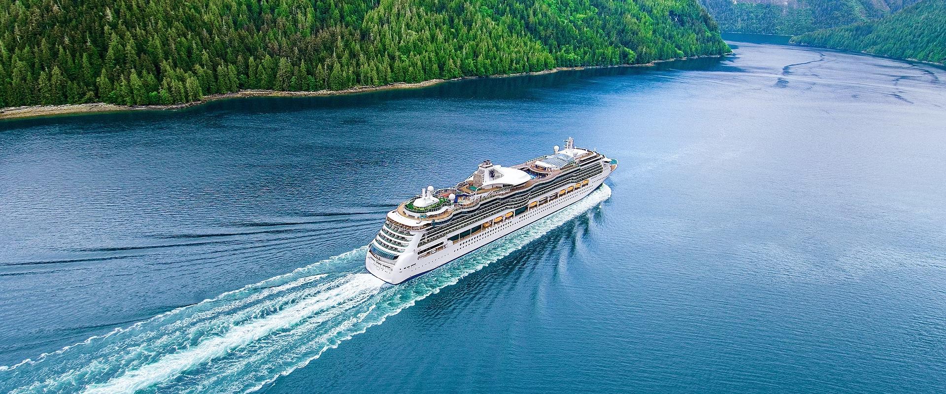 Serenade of the Seas Cruising Through Alaskan Fjord Serenade of the Seas cruise ship navigating an Alaskan fjord surrounded by evergreen forests