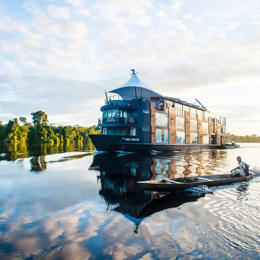 The Aria Amazon, a blue-hulled expedition cruise ship with distinctive conical pilothouse, is