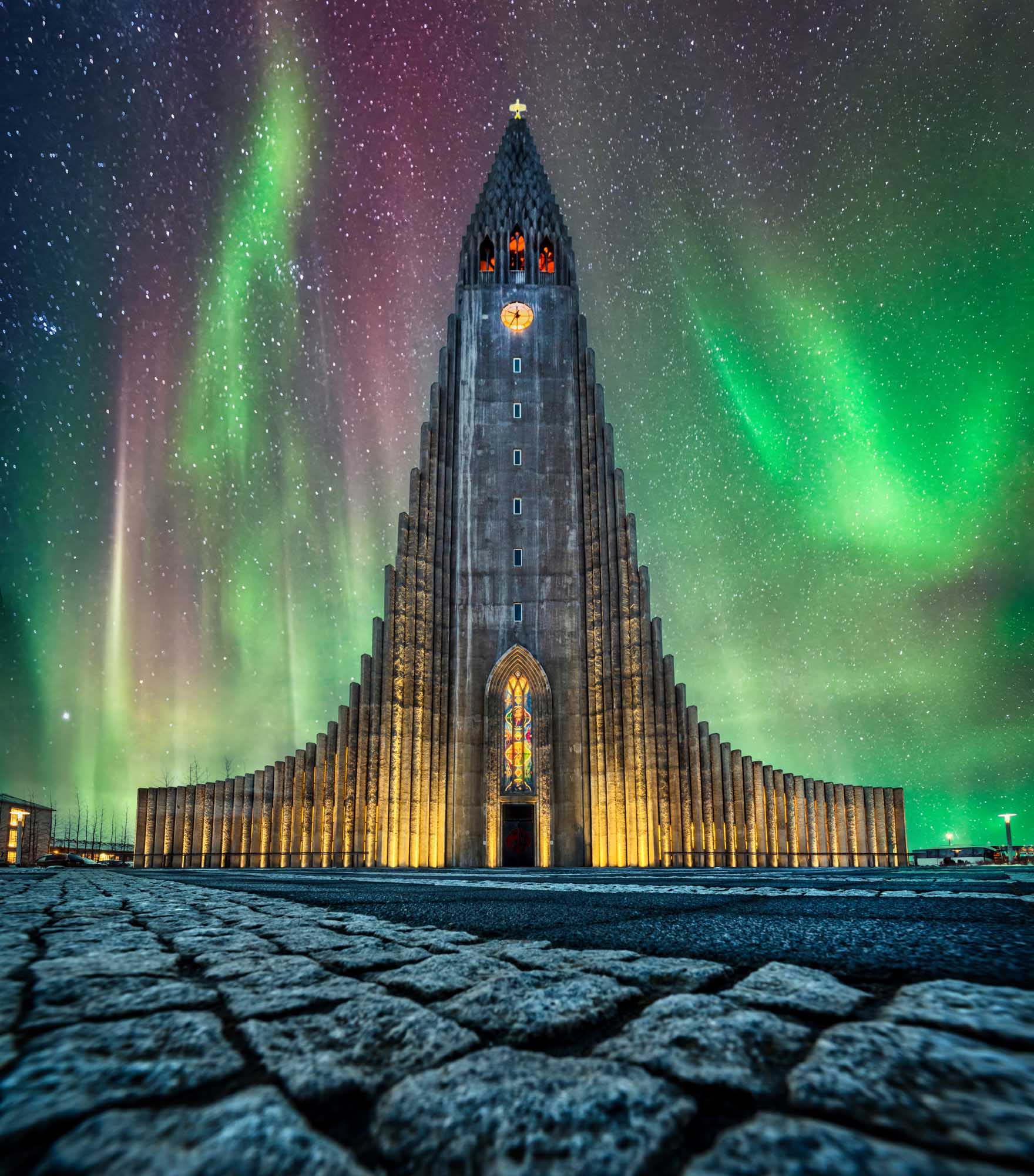 A stunning night photograph of the Northern Lights dancing vibrantly above the iconic