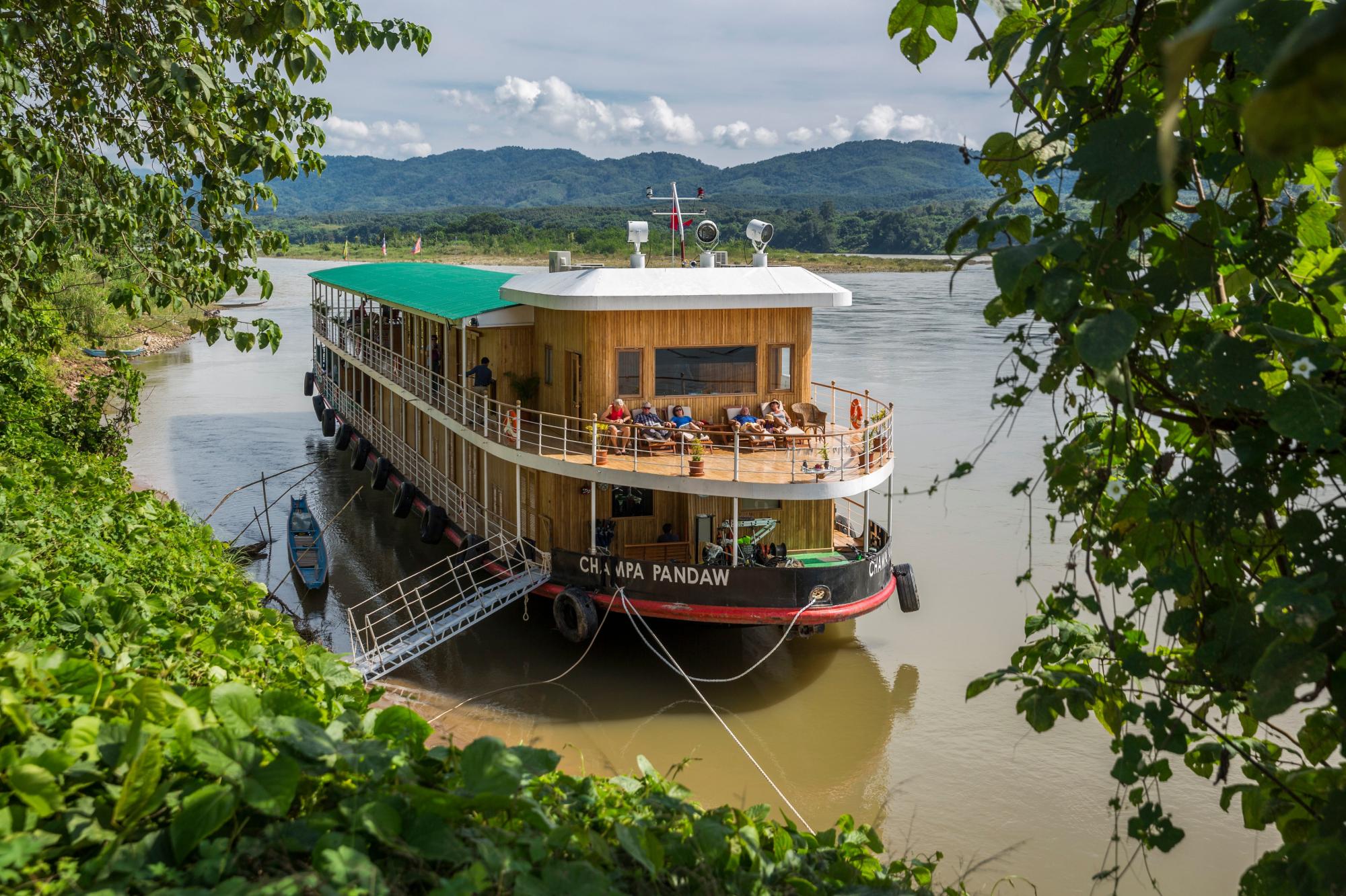 Champa Pandaw River Cruise Ship on Mekong River The Champa Pandaw, a luxury river cruise vessel, is moored along the Mekong River with passengers