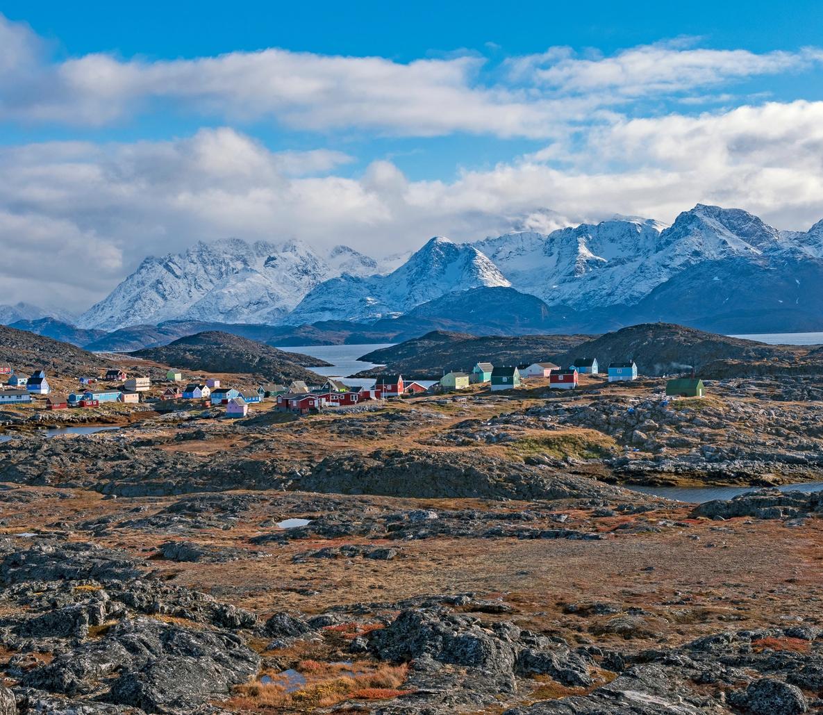 Colorful Arctic village with snowy mountains and fjord in Greenland