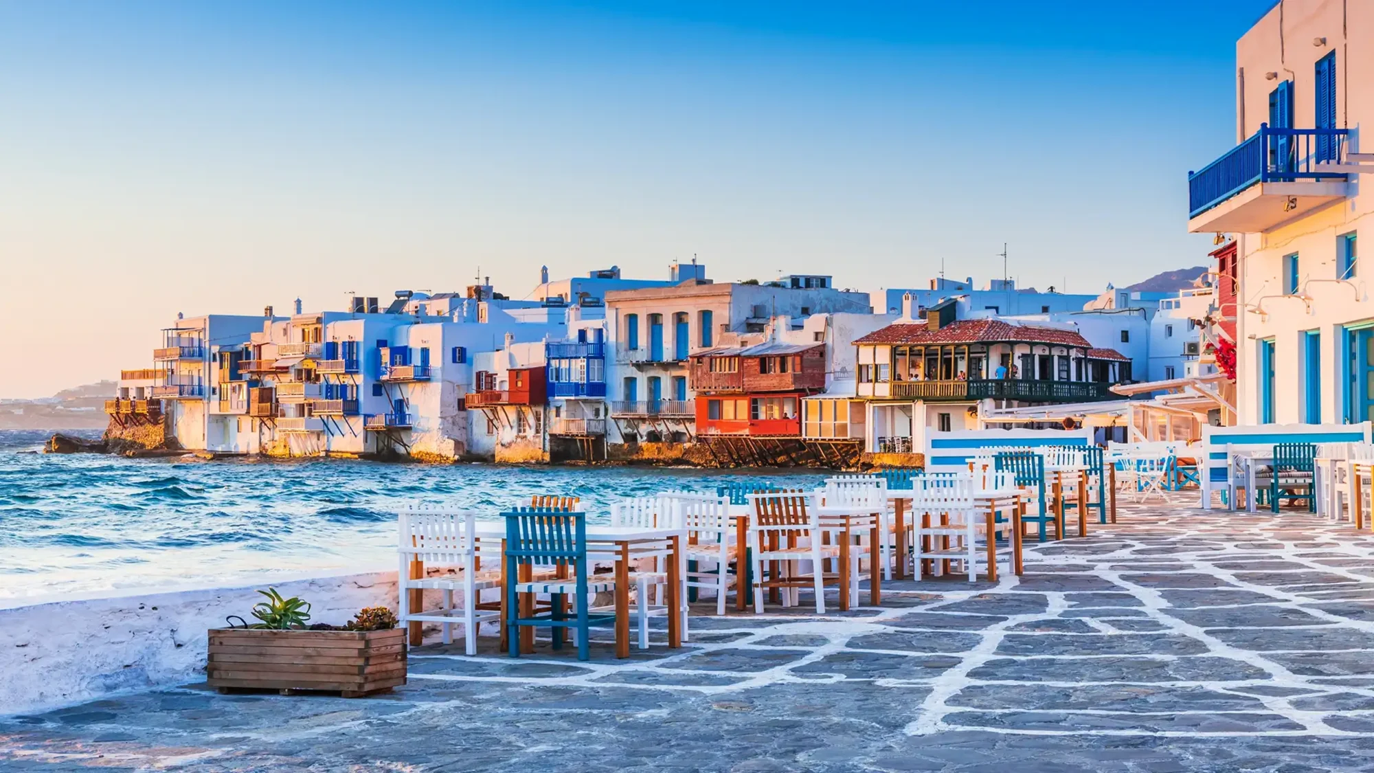 A picturesque Greek island village featuring traditional Cycladic architecture with vibrant blue