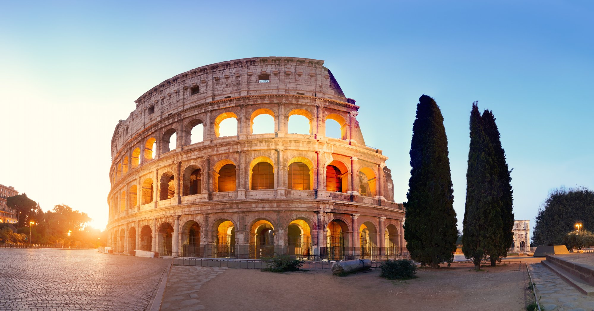 The Colosseum glows in golden sunset light in Rome, Italy