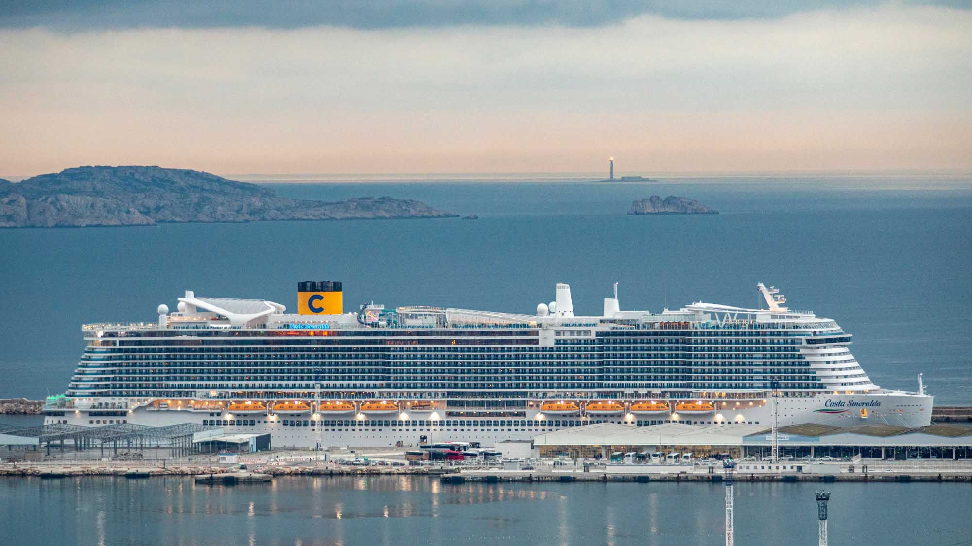 Costa Smeralda cruise ship docked at European port with Mediterranean islands visible