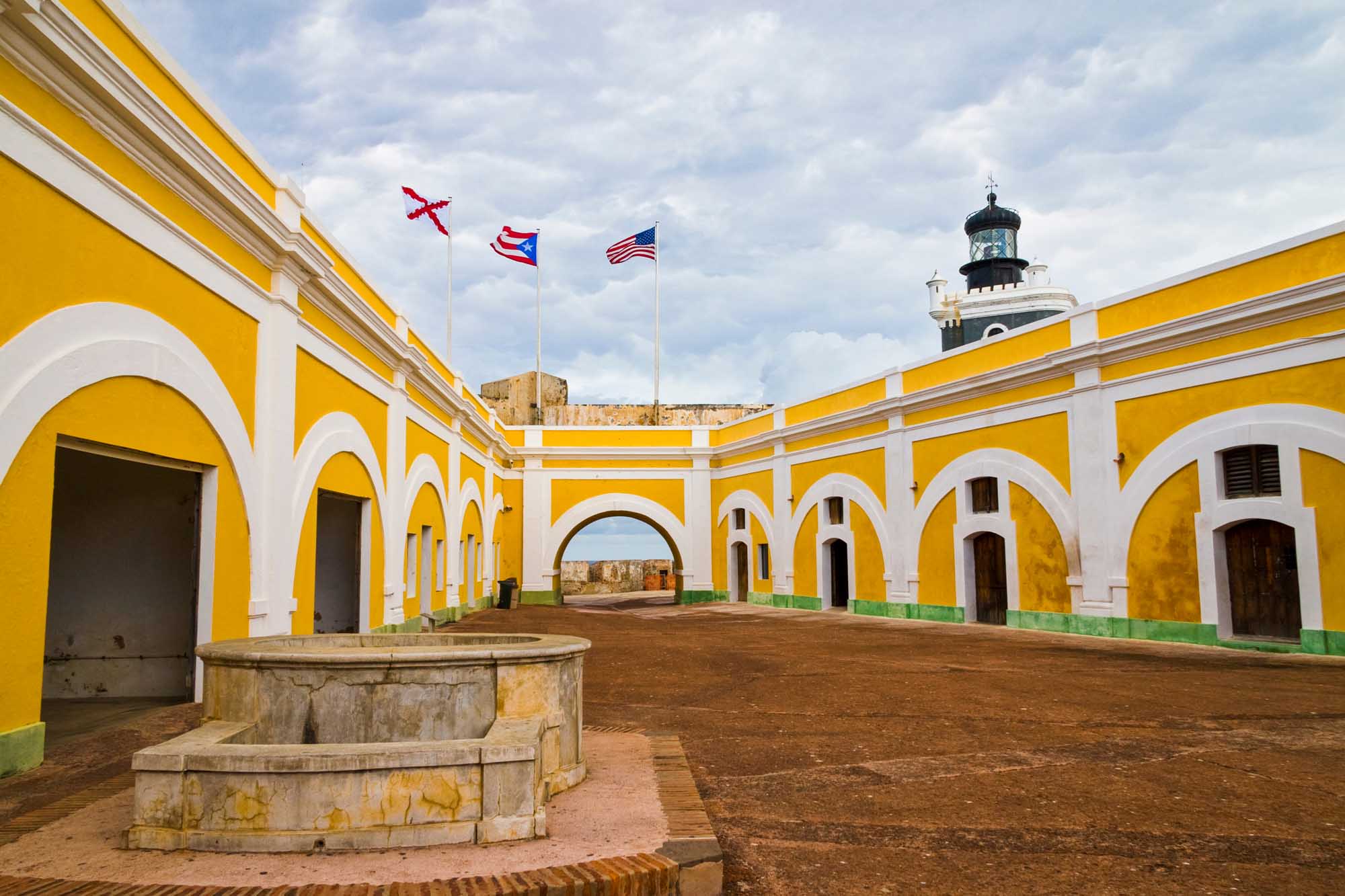 Fort San Felipe del Morro's iconic yellow and white colonial courtyard with arched galleries