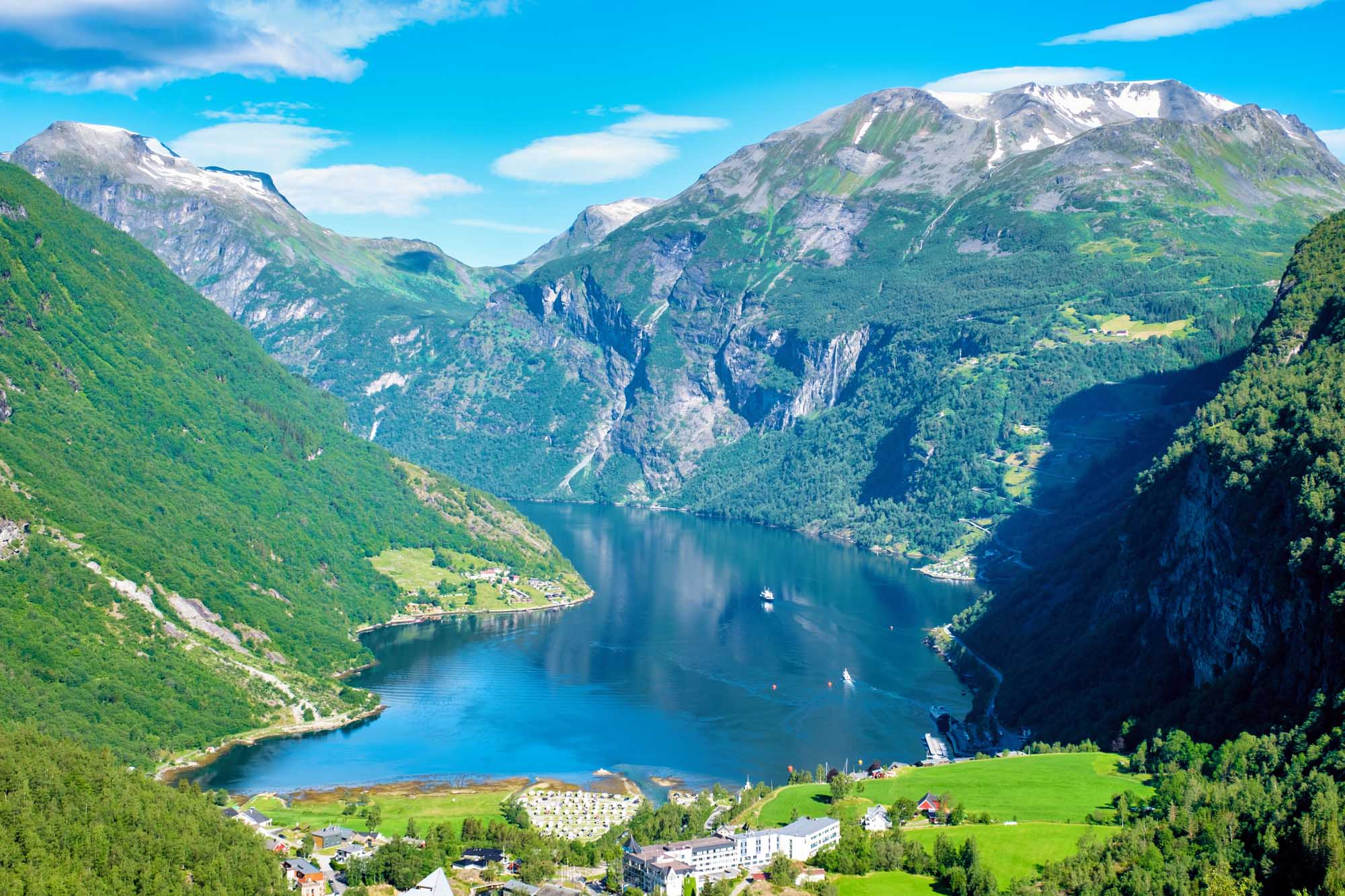 Geirangerfjord Norway Alpine Valley and Lake A breathtaking panoramic view of Geirangerfjord in Norway, featuring a pristine deep-blue fjord