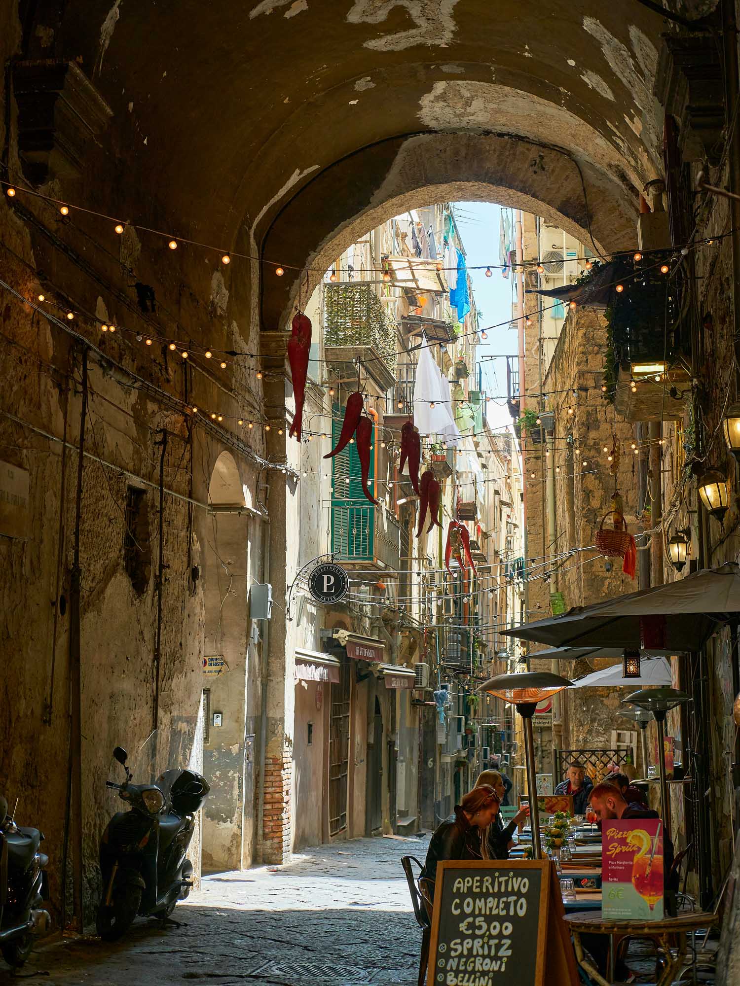 A charming narrow alley in a historic Italian city, featuring weathered stone architecture