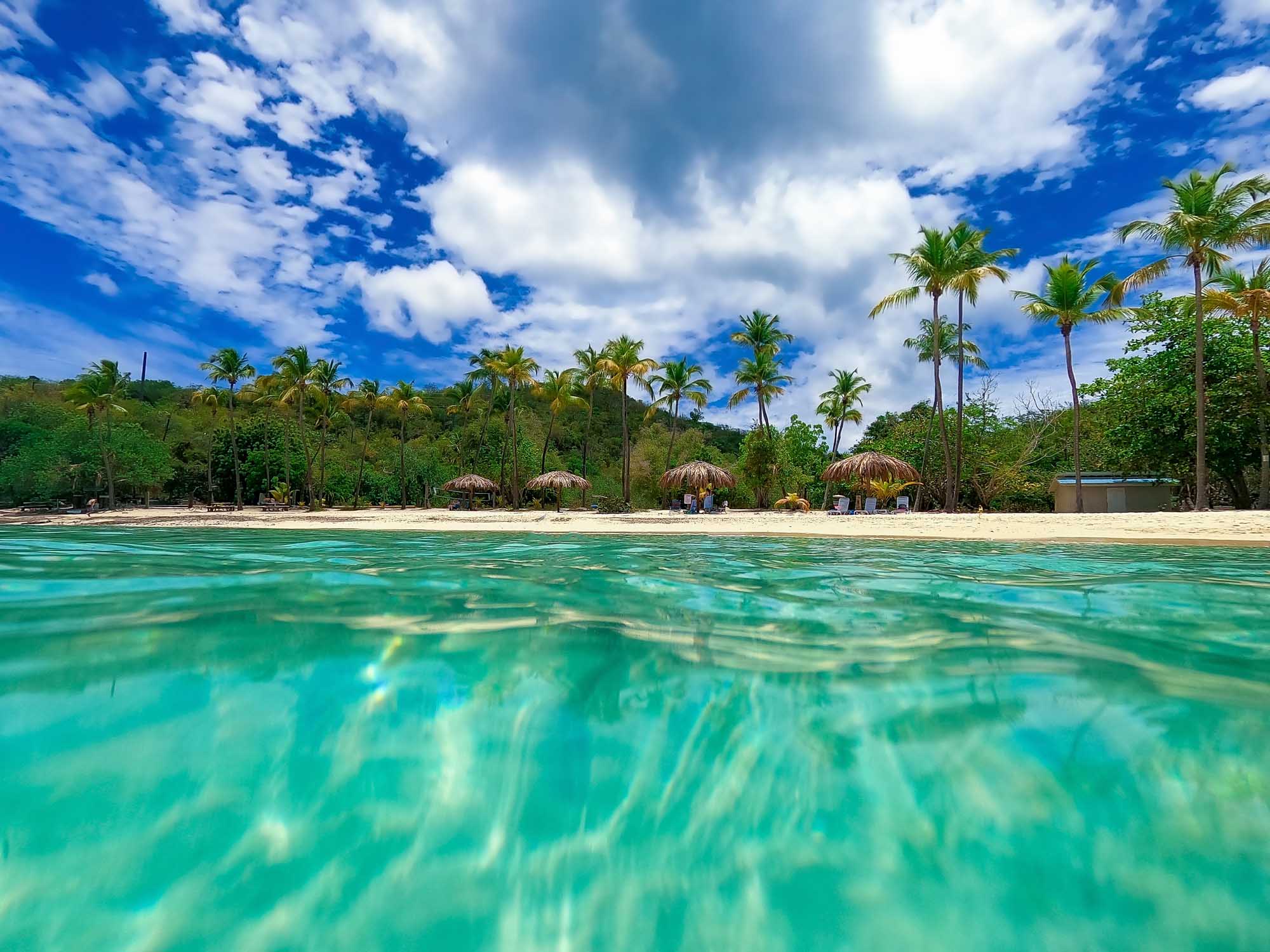 Pristine turquoise waters and white sand at Honeymoon Beach, St. Thomas, US Virgin Islands