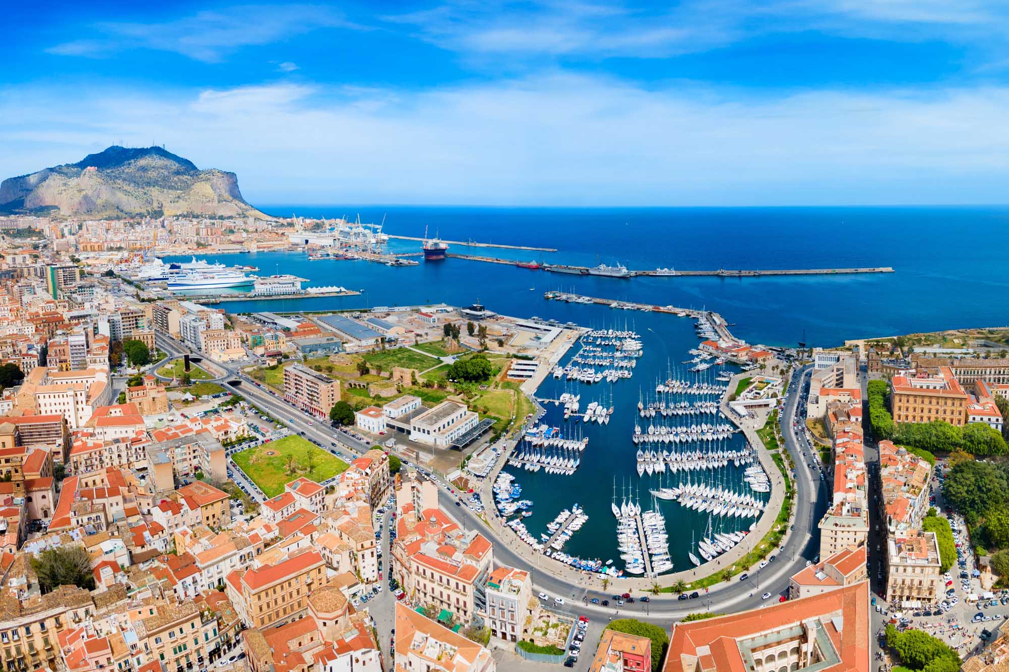 An expansive aerial view of Palermo, Sicily's capital, showcasing the picturesque harbor filled
