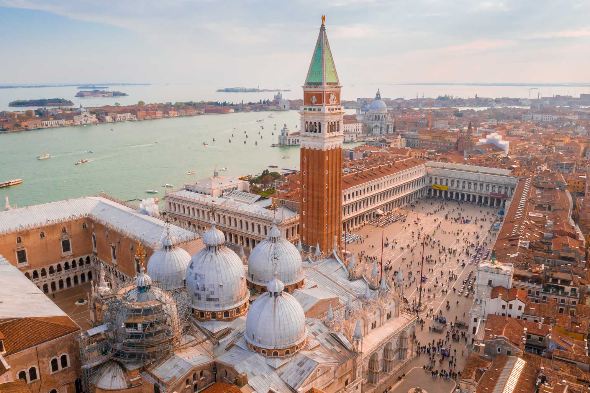 An aerial view of Venice's iconic St. Mark's Square featuring the ornate St. Mark's Basilica
