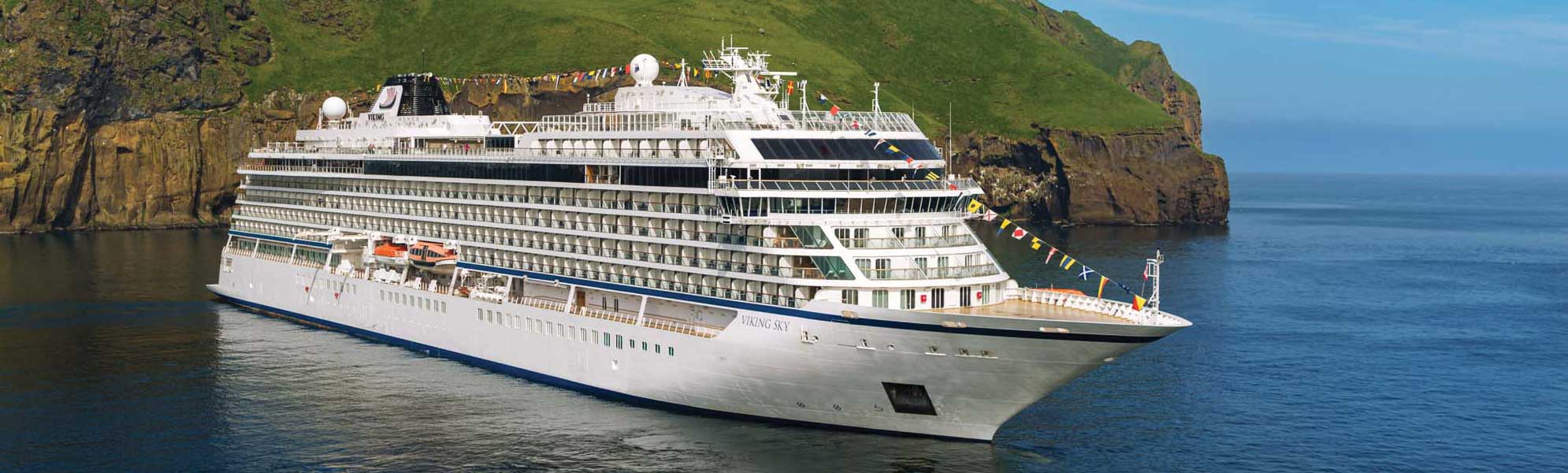 Viking Sky Cruise Ship in Norwegian Fjord The Viking Sky luxury cruise ship anchored in a Norwegian fjord with green cliffs