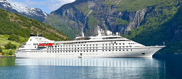 Windstar Cruises Star Legend in Norwegian Fjord Windstar Cruises' Star Legend navigating a dramatic Norwegian fjord surrounded by steep cliffs