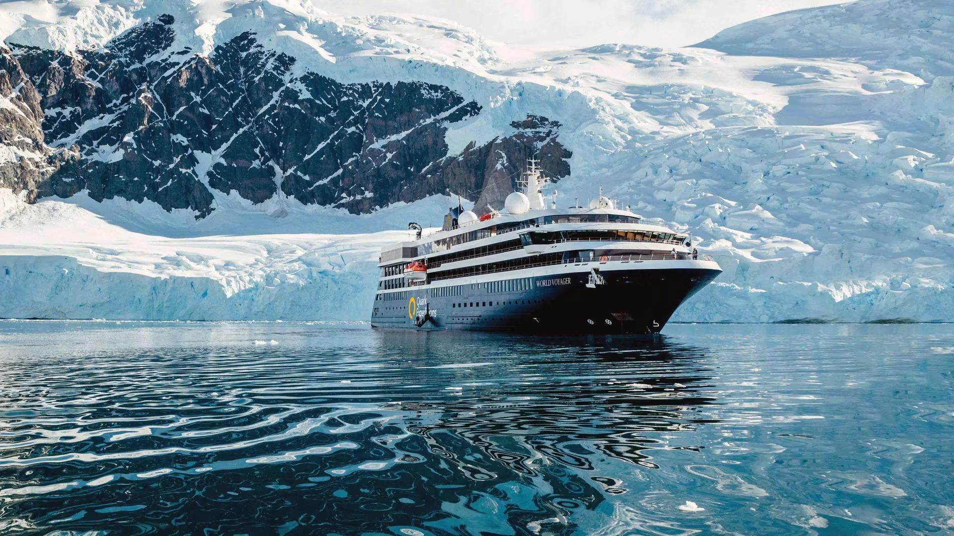 The expedition cruise ship World Voyager surrounded by icebergs in Antarctic waters
