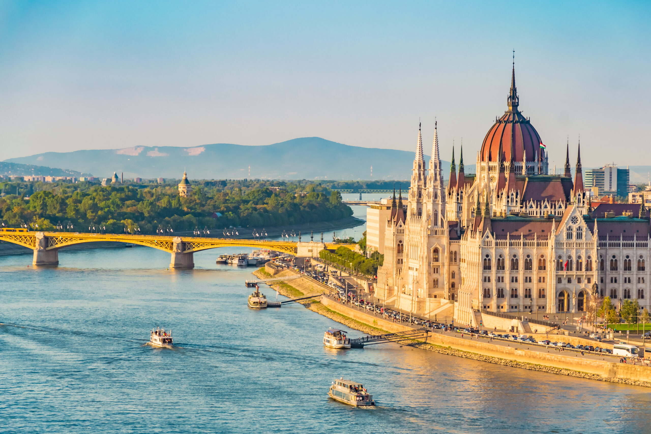 River cruise boats passing the Hungarian Parliament on the Danube in Budapest