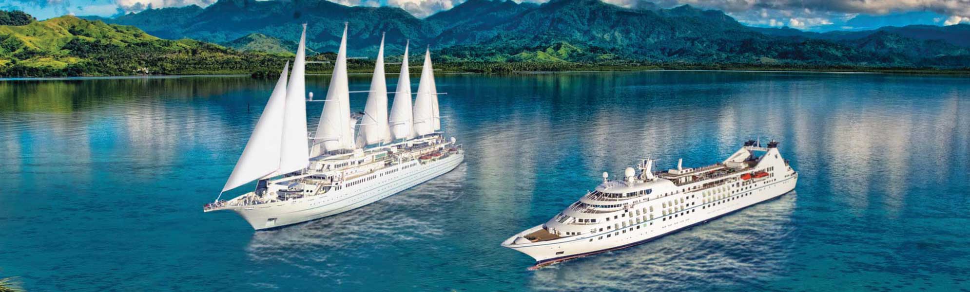 Luxury Cruise Ships in Tropical Waters Two elegant cruise ships anchor in crystal-clear tropical waters with lush green mountains
