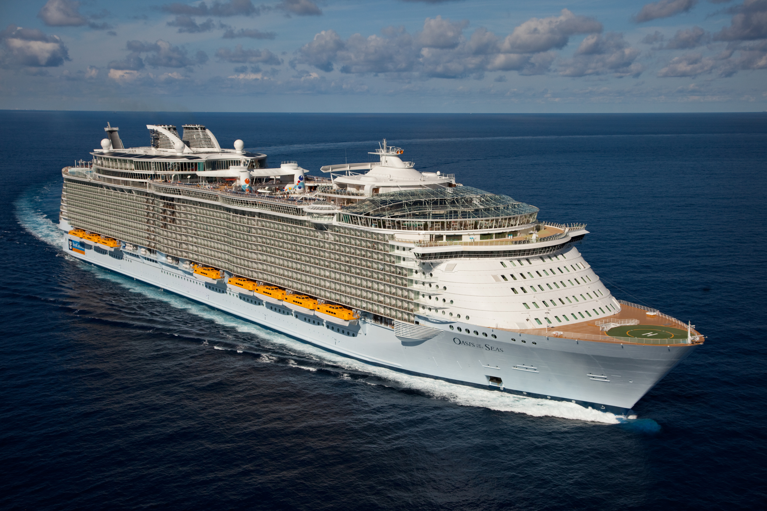 Oasis of the Seas Cruise Ship at Sea An aerial view of the Oasis of the Seas, a massive modern cruise ship, cutting through deep blue