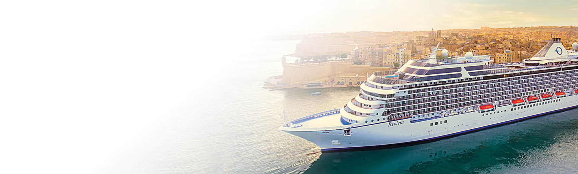 A large modern cruise ship named Riviera is docked at a Mediterranean port with the golden