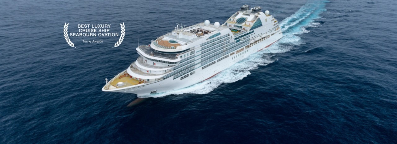 Seabourn Ovation Luxury Cruise Ship at Sea An aerial view of the Seabourn Ovation, a modern luxury cruise ship, cutting through deep blue