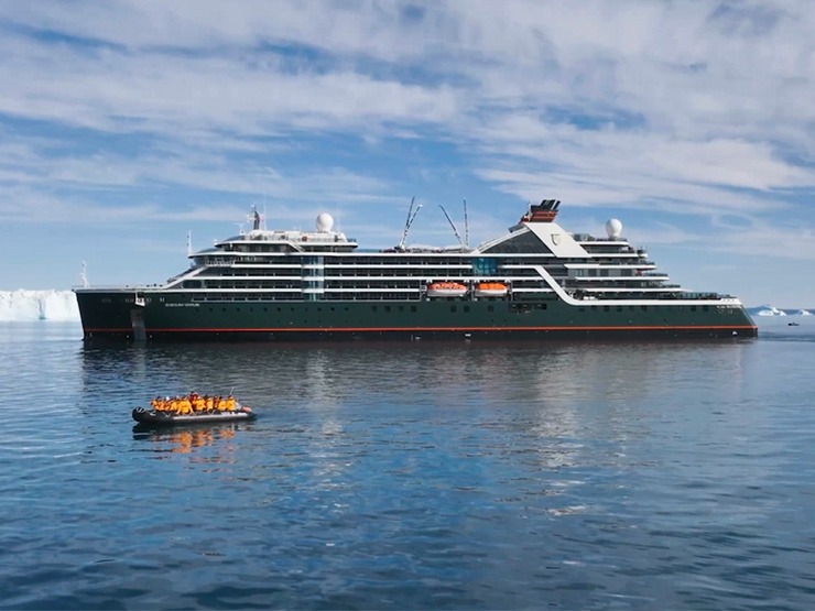 Seabourn Pursuit Expedition Cruise Ship with Tender A modern luxury expedition cruise ship, the Seabourn Pursuit, anchored in clear Arctic waters