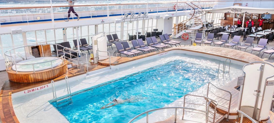 Silversea Cruise Ship Pool Deck An expansive pool deck aboard a Silversea luxury cruise ship, featuring a sparkling blue swimming