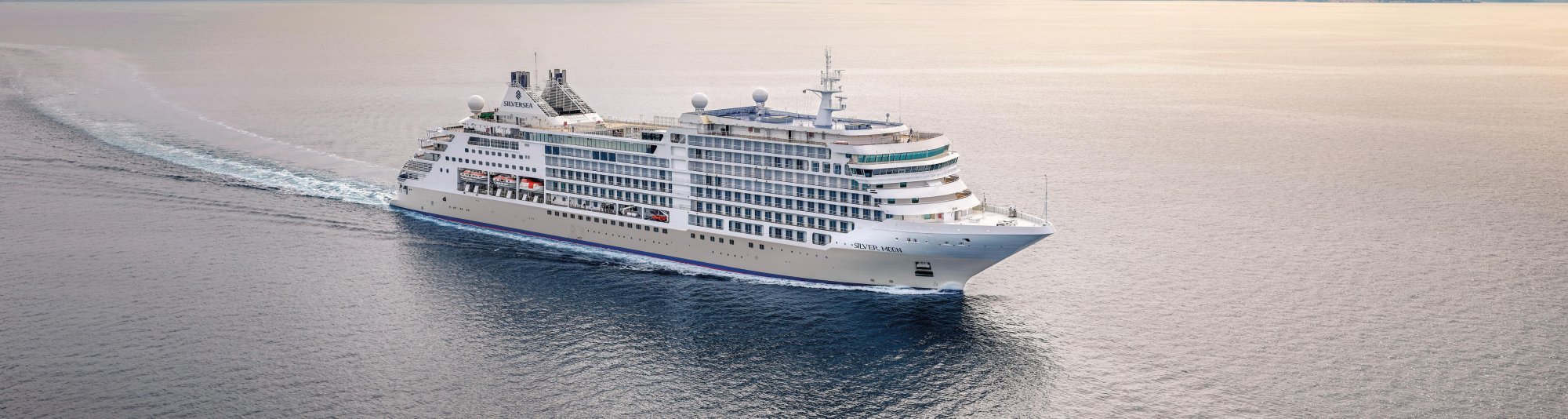 Silversea Luxury Cruise Ship at Sea A magnificent Silversea luxury cruise ship navigates calm blue waters, showcasing its elegant white