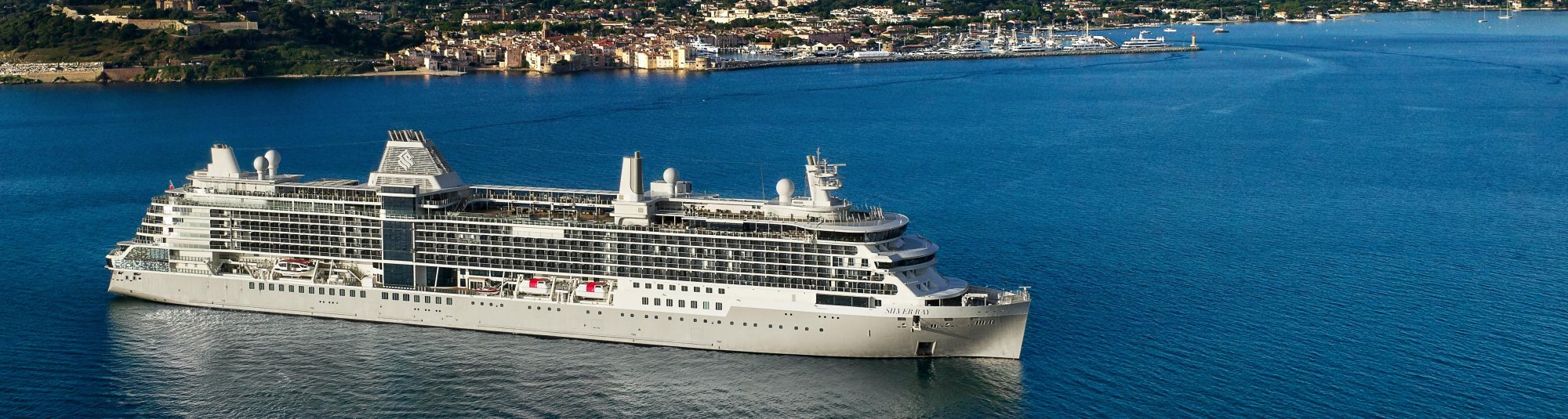 Silversea Luxury Cruise Ship in Mediterranean Waters A large luxury cruise ship operated by Silversea anchored in crystalline blue Mediterranean waters