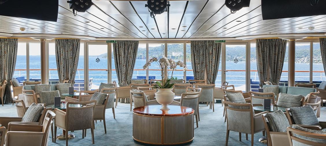 Silversea Luxury Lounge with Panoramic Ocean Views An elegant and sophisticated lounge aboard a Silversea cruise ship, featuring floor-to-ceiling
