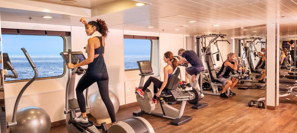 Silversea Ship Fitness Center with Ocean Views A modern fitness center aboard a Silversea cruise ship, featuring multiple passengers exercising
