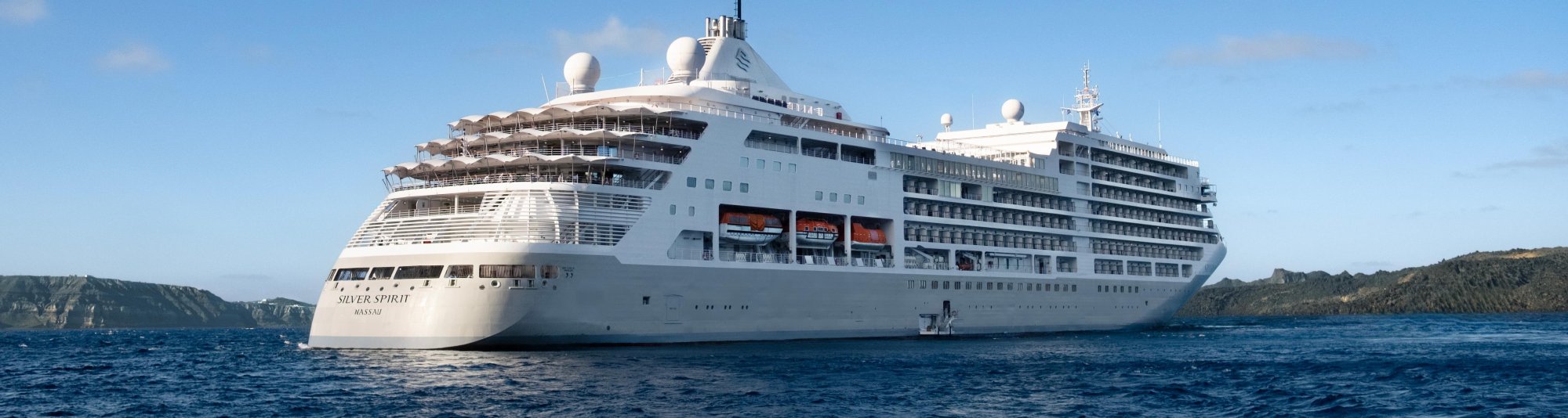 Silversea Silver Spirit Cruise Ship at Anchor The luxurious Silversea Silver Spirit cruise ship is anchored in clear blue waters with forested