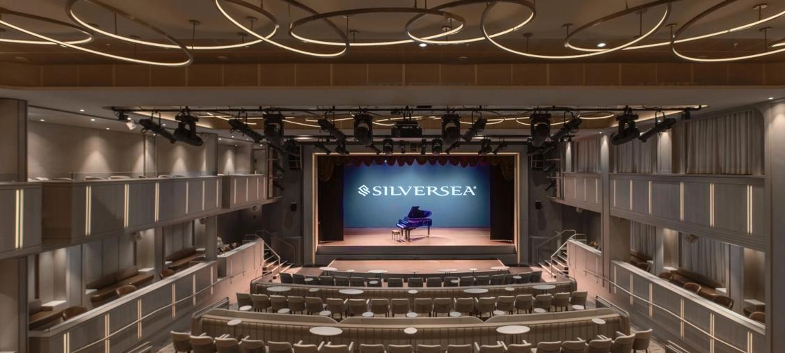 Silversea Theatre with Grand Piano on Stage An elegant theatre venue aboard a Silversea cruise ship, featuring tiered seating, professional