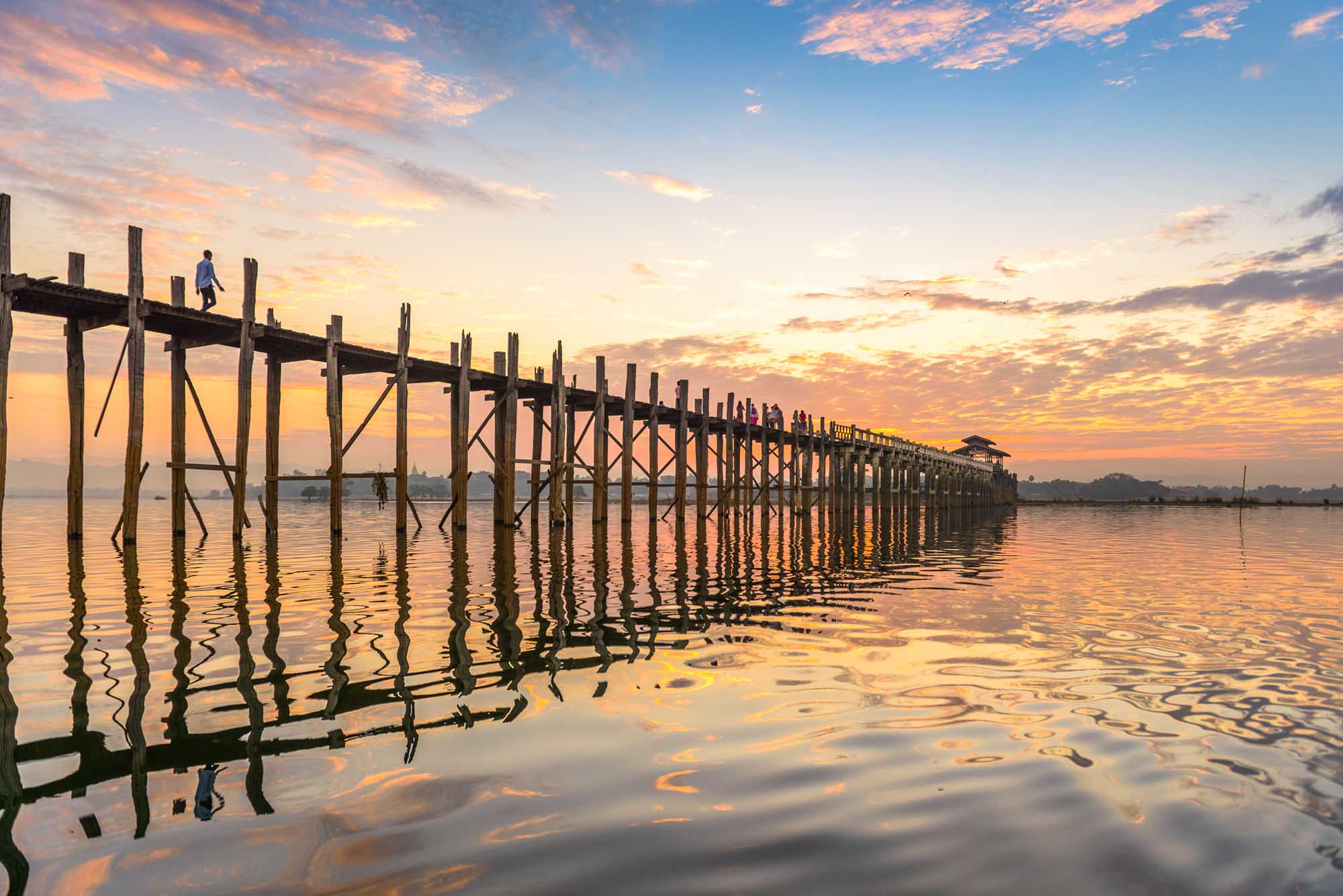 U-Bein Bridge at Sunset, Mandalay A stunning sunrise or sunset view of the iconic U-Bein Bridge spanning across Taungthaman Lake